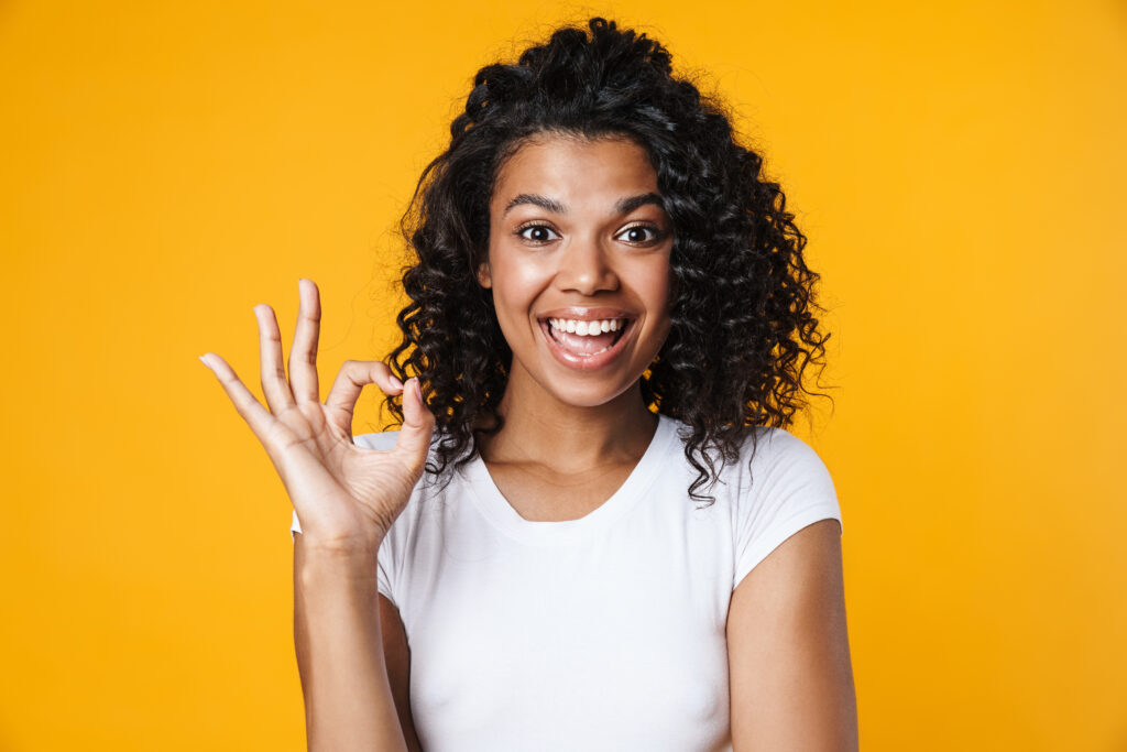 Image Of Joyful African American Woman Gesturing Ok Sign And Smiling